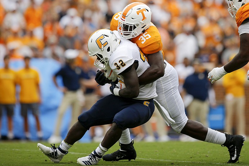 Staff photo by C.B. Schmelter / Tennessee linebacker Daniel Bituli (35) tackles UTC running back Ailym Ford (32) during a NCAA football game at Neyland Stadium on Saturday, Sept. 14, 2019 in Knoxville, Tenn.