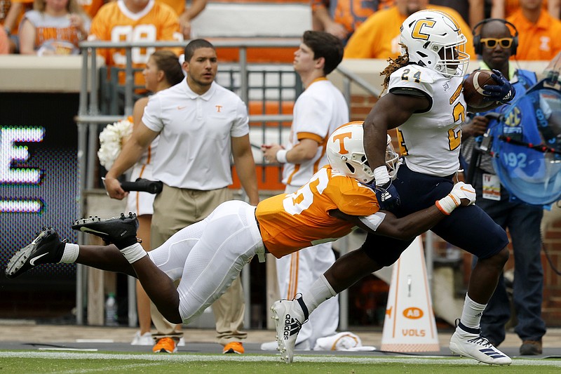 Staff photo by C.B. Schmelter / Tennessee defensive back Theo Jackson tackles UTC running back Elijah Ibitokun-Hanks during Saturday's game at Neyland Stadium in Knoxville.