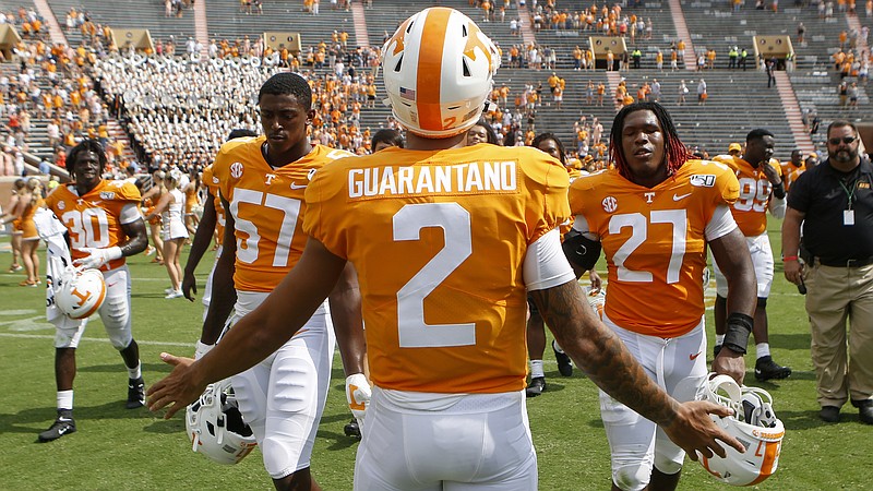 Tennessee quarterback Jarrett Guarantano greets his teammates as they make their way to the locker room after their 45-0 win over UTC in September. / Staff photo by C.B. Schmelter