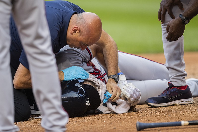 Associated Press photo by Manuel Balce Ceneta / Atlanta Braves batter Charlie Culberson is attended to on the ground near home plate after getting hit by a pitch during the seventh inning of Saturday's game against the host Washington Nationals.