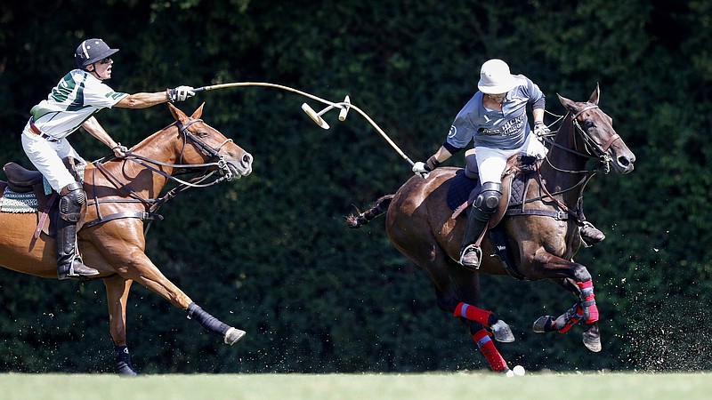 Staff photo by C.B. Schmelter / The mallets of Bendabout's Owen Rinehart, left, and Old Hickory Bourbon's Will Johnston get tangled during a polo match at Bendabout Farm on Sunday, Sept. 15, 2019 in McDonald, Tenn.