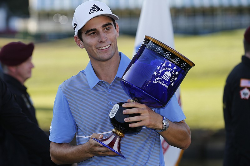 Associated Press photo by Steve Helber / Joaquin Niemann holds the winner's trophy as he celebrates his first PGA Tour victory Sunday at A Military Tribute at The Greenbrier. Niemann won by six strokes and became the first golfer from Chile to win on the PGA Tour.
