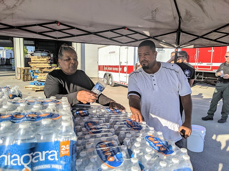 Staff photo by Sarah Grace Taylor / Cassandra Weakly, 66, and her son John Davis, 49, volunteer with the Chattanooga Police Department during a city-wide water outage on Sunday, September 16, 2019. Weakly and Davis drove from Knoxville to "share a blessing" with struggling Chattanoogans.
