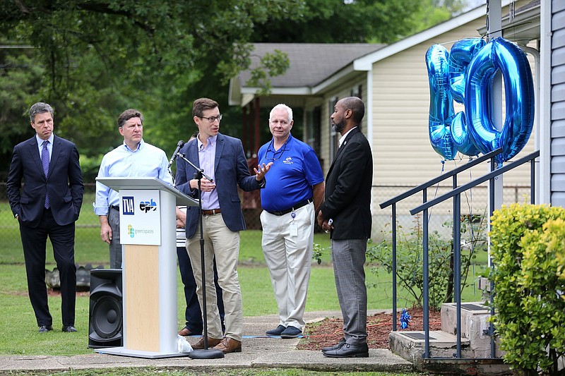 File Staff photo by Erin O. Smith / Green Spaces executive director Michael Walton talks about EPB's Home Energy Upgrade program at the home of East Chattanooga resident Hazel Benford, the 250th homeowner to receive the energy improvements in Chattanooga. Also at the June event, from left, were Mayor Andy Berke, TVA CEO Jeff Lyash, EPB President David Wade and City Council member Anthony Byrd.