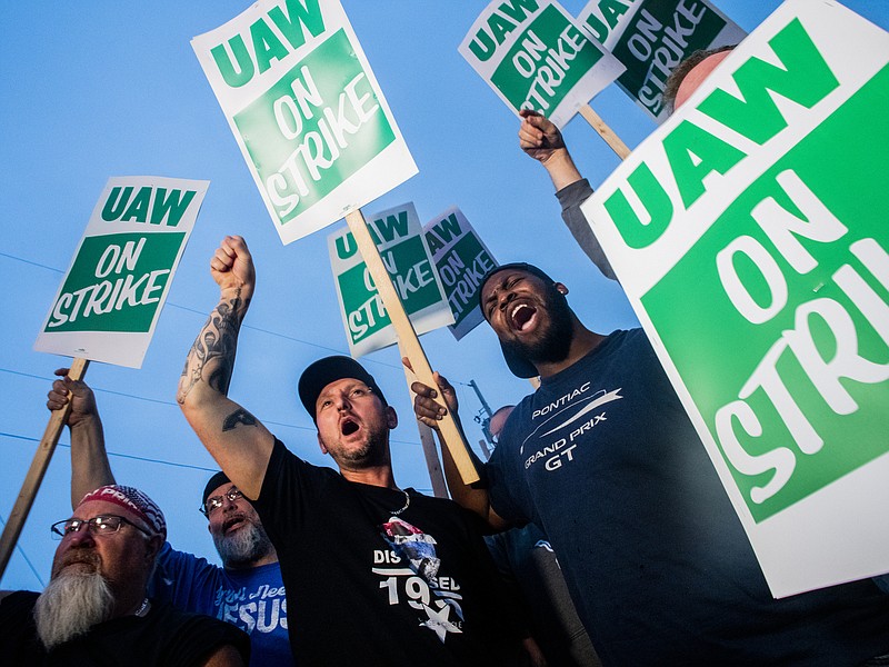 General Motors employees Bobby Caughel, left, and Flint resident James Crump, shout out as they protest with other GM employees, United Auto Workers members and labor supporters outside of the Flint Assembly Plant on Monday, Sept. 16, 2019 in Flint, Mich. Thousands of members of the United Auto Workers walked off General Motors factory floors or set up picket lines early Monday as contract talks with the company deteriorated into a strike. (Jake May/The Flint Journal via AP)