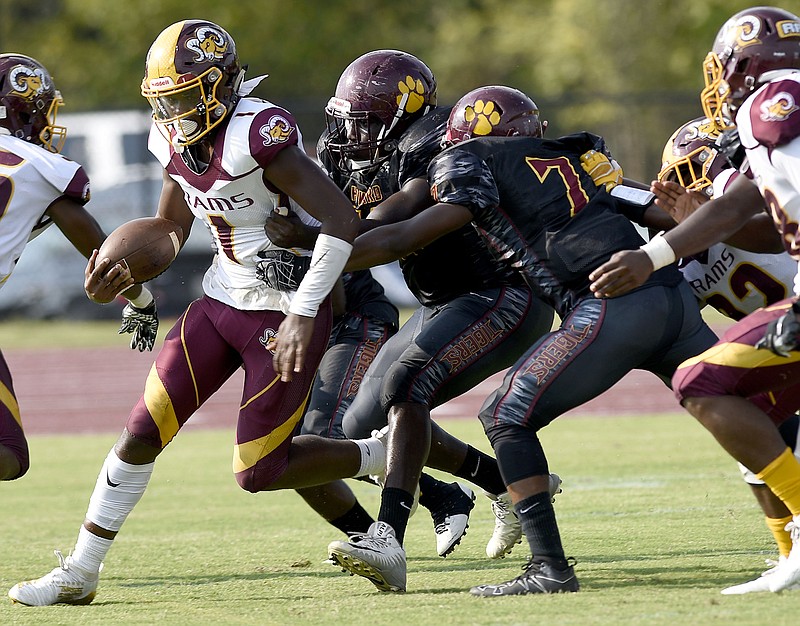 Staff Photo by Robin Rudd/  Tyner quarterback Martavius Ryals (1) is chased by the Howard defense.  The Howard Hustling Tigers hosted the Tyner Rams in TSSAA football on September 14, 2019.  