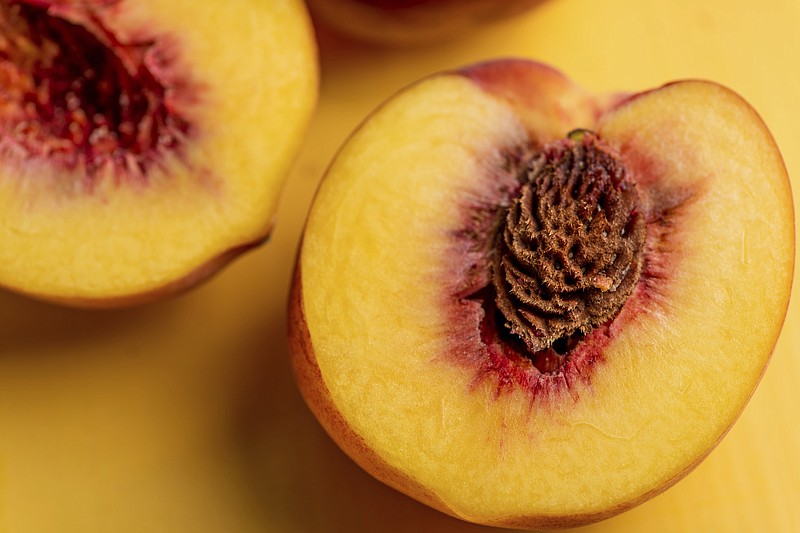 This August 2018 photo shows peaches in New York. In the last warm weeks of summer, it's hard to imagine that all of today's tomatoes and corn and peaches will be but memories in just a couple of months. With a bit of forethought, and a bit of time, we can safeguard some of this magnificent produce and draw upon it all winter long. When you preserve food, you are using techniques to stop its natural decomposition, killing or preventing the growth of microbes. (Cheyenne Cohen/Katie Workman via AP)