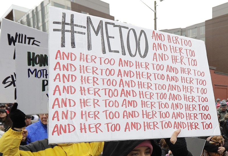 In this Jan. 20, 2018 file photo, a marcher carries a sign with the popular Twitter hashtag #MeToo used by people speaking out against sexual harassment as she takes part in a Women's March in Seattle. According to a study published Monday, Sept. 16, 2019, the first sexual experience for many U.S. women was forced or coerced intercourse in their early teens, encounters that for some may have had lasting health repercussions. (AP Photo/Ted S. Warren, File)