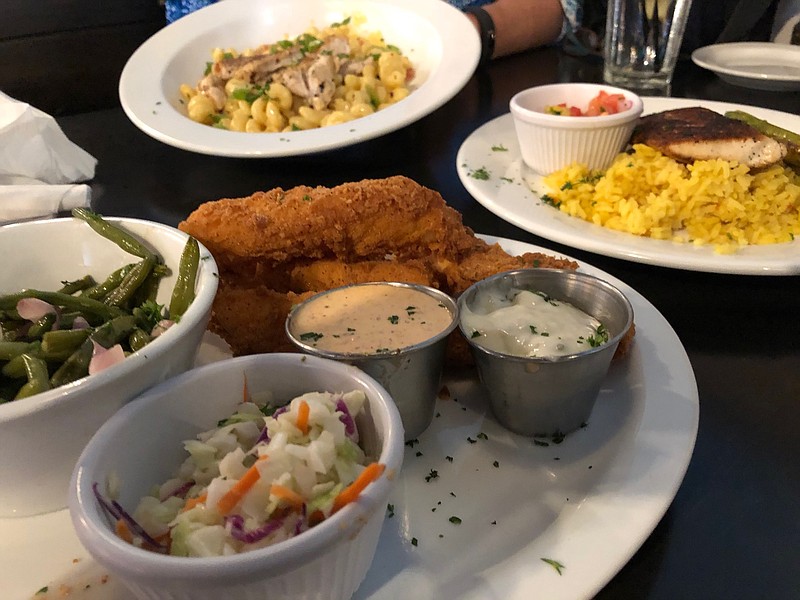 Staff Photo by Susan Pierce / Tavern Mac & Cheese with Chicken, Blackened Mahi and Fish & Chips, clockwise from top.