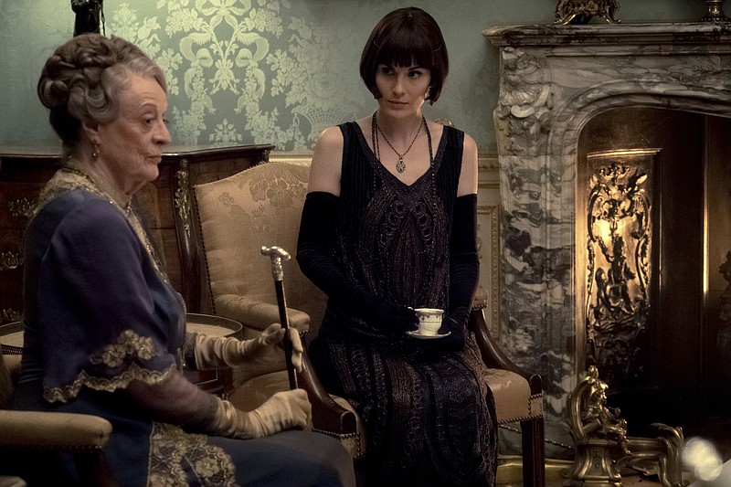 This image released by Focus Features shows Dame Maggie Smith as The Dowager Countess of Grantham and Michelle Dockery as Lady Mary Talbot in "Downton Abbey". The film will be released Sept. 13, 2019, in the United Kingdom and on Sept. 20 in the United States. (Jaap Buitendijk/Focus Features via AP)