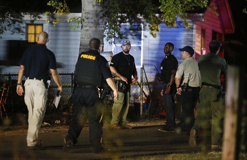 In this Monday, Sept. 16, 2019 photo, Tuscaloosa Police officers and Tuscaloosa Violent Crimes Unit investigators work at the scene where Tuscaloosa Police Investigator Dornell Cousette, was shot and killed in Tuscaloosa, Ala. Cousette was attempting to serve a warrant on a man in the city's West End when the suspect opened fire. Cousette was able to return fire, wounding the shooter. The suspect was later taken into custody by Tuscaloosa Police. (Gary Cosby Jr./The Tuscaloosa News via AP)


