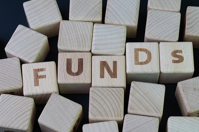 Mutual funds, investment asset selection by performance concept, cube wooden block with alphabet combine the word abbreviation FUNDs on black chalkboard background. / Getty Images exchange trade funds tile business tile 
