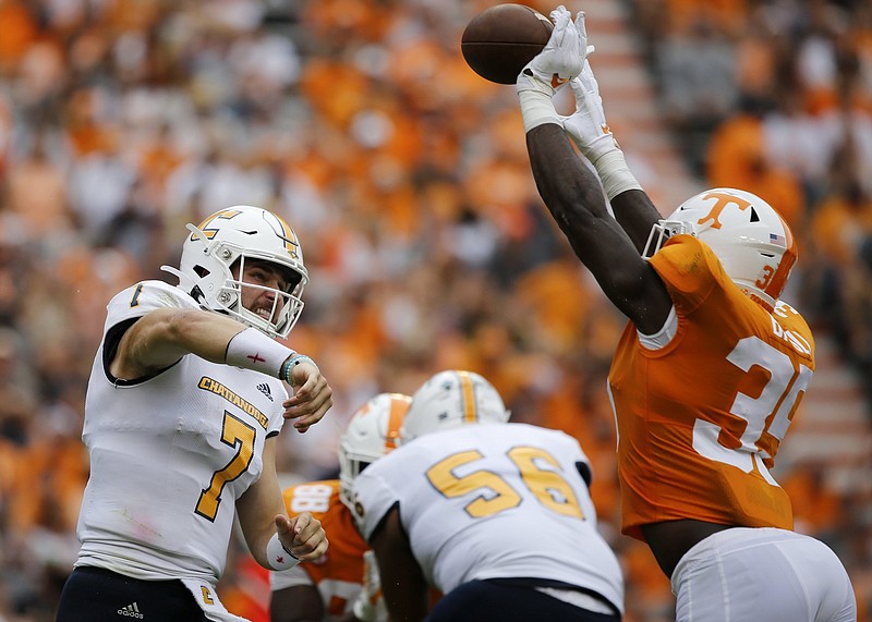 Staff photo by C.B. Schmelter / Tennessee linebacker Daniel Bituli reaches to knock down a pass by UTC quarterback Nick Tiano during last Saturday's game at Neyland Stadium.