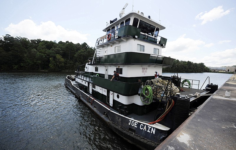 In this Tuesday, July 23, 2019 photo, crew members aboard the Mobile, Ala.-based tugboat Joe Cain prepare to depart the Yellow Creek State Inland Port on the Tennessee-Tombigbee Waterway at Iuka, Miss. The waterway hasn't lived up to expectations in terms of barge traffic or economic development in parts of Alabama and Mississippi, but the port provides jobs and helps the economy in Iuka, located near the Tennessee line. (AP Photo/Jay Reeves)