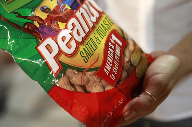 FILE - In this July 31, 2010 file photo, Morgan Parmet, 24, of Washington, holds a bag of peanuts that she bought at Nationals Park, as the Philadelphia Phillies play against the Washington Nationals, in Washington. (AP Photo/Jacquelyn Martin, File)


