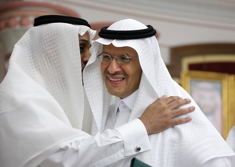 Energy Minister Prince Abdulaziz bin Salman smiles as he is congratulated after a press conference in Jiddah, Saudi Arabia, Tuesday, Sept. 17, 2019. Saudi Arabia's energy minister said Tuesday that 50% of its daily crude oil production that was knocked out by a weekend attack had been restored and that full production is expected by the end of the month.(AP Photo/Amr Nabil)