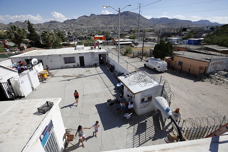 In this July 30, 2019, photo, people walk through the patio at El Buen Pastor shelter for migrants in Cuidad Juarez, Mexico. (AP Photo/Gregory Bull)