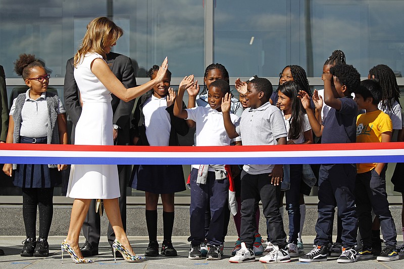 First lady Melania Trump high-fives students from Amidon-Bowen Elementary School in Washington as she arrives at a ribbon-cutting ceremony to re-open the Washington Monument, Thursday, Sept. 19, 2019, in Washington. The monument has been closed to the public for renovations since August 2016. (AP Photo/Patrick Semansky)