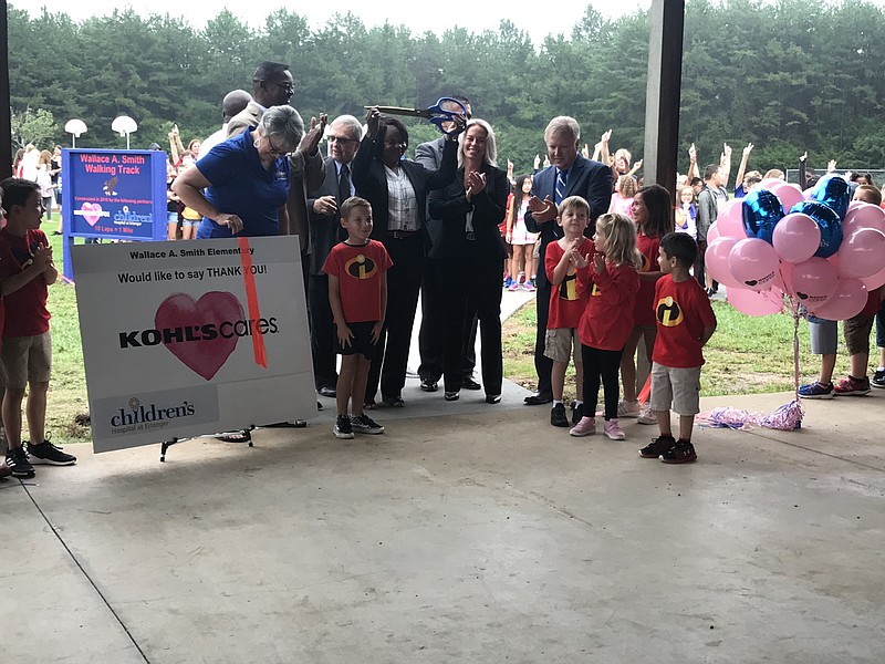 Staff photo by Emily Crisman / Wallace A. Smith Elementary School principal Sharon Dodds holds up the scissors used for the ribbon-cutting ceremony for the school's new walking track.