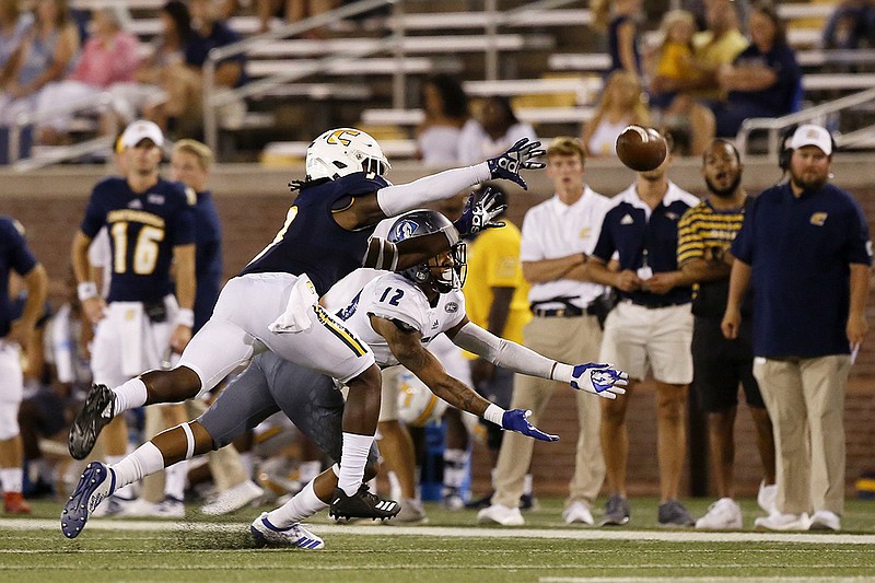 Staff photo by C.B. Schmelter / UTC's Rashun Freeman, left, makes a play on a pass to Eastern Illinois wide receiver Marques Ray during the season opener for both teams on Aug. 29 at Finley Stadium.