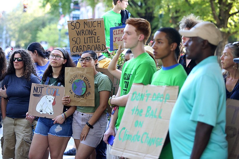 Staff photo by Erin O. Smith / Young people hold up signs during a Climate Strike on Friday in front of the Tennessee Aquarium. A candlelit climate vigil also is planned for Friday near the Hunter Museum.