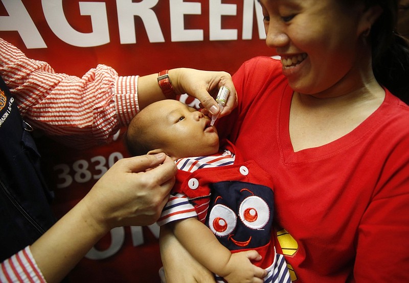 A baby gets an oral anti-polio vaccine during the launch of a campaign to end the resurgence of polio after health authorities confirmed a polio case in the country Friday, Sept. 20, 2019 at suburban Quezon city northeast of Manila, Philippines. Philippine health officials declared a polio outbreak in the country on Thursday, nearly two decades after the World Health Organization declared it to be free of the highly contagious and potentially deadly disease. (AP Photo/Bullit Marquez)
