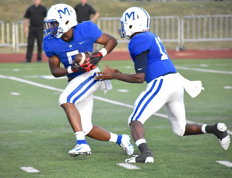 Staff photo by Patrick MacCoon / McCallie junior running back B.J. Harris takes the handoff from DeAngelo Hardy in a region game against Knoxville Catholic on Friday night at Spears Stadium. Harris helped carry the top-ranked Blue Tornado to victory.