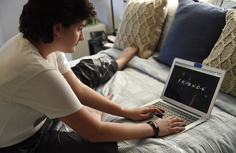 In this Thursday, Aug. 22, 2019 photo, Esme Goldman, 13, streams an episode of the '90s sitcom "Friends" via Netflix in her bedroom, in Pasadena, Calif. "Friends" marks its 25th anniversary Sunday, Sept. 22 and the quintessential 1990s sitcom has attracted a new slew of viewers who are barely half that age. Tween and teen girls in particular have embraced the show with huge enthusiasm, taking a show that belonged to Generation X and making it their own. (Photo by Chris Pizzello/Invision/AP)


