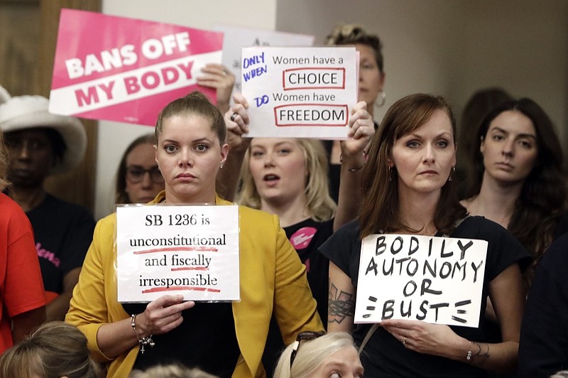 FILE - In this Aug. 12, 2019 file photo, people wait for a Senate hearing to begin to discuss a fetal heartbeat abortion ban, or possibly something more restrictive in Nashville, Tenn. Four years after Tennessee passed a law requiring a 48-hour waiting period for women seeking abortions, a lawsuit challenging the statute's constitutionality is finally going to trial. Beginning Monday, Sept. 23, attorneys for five of the state's seven abortion clinics will argue in federal court that the law harms the women it is supposed to help.(AP Photo/Mark Humphrey)


