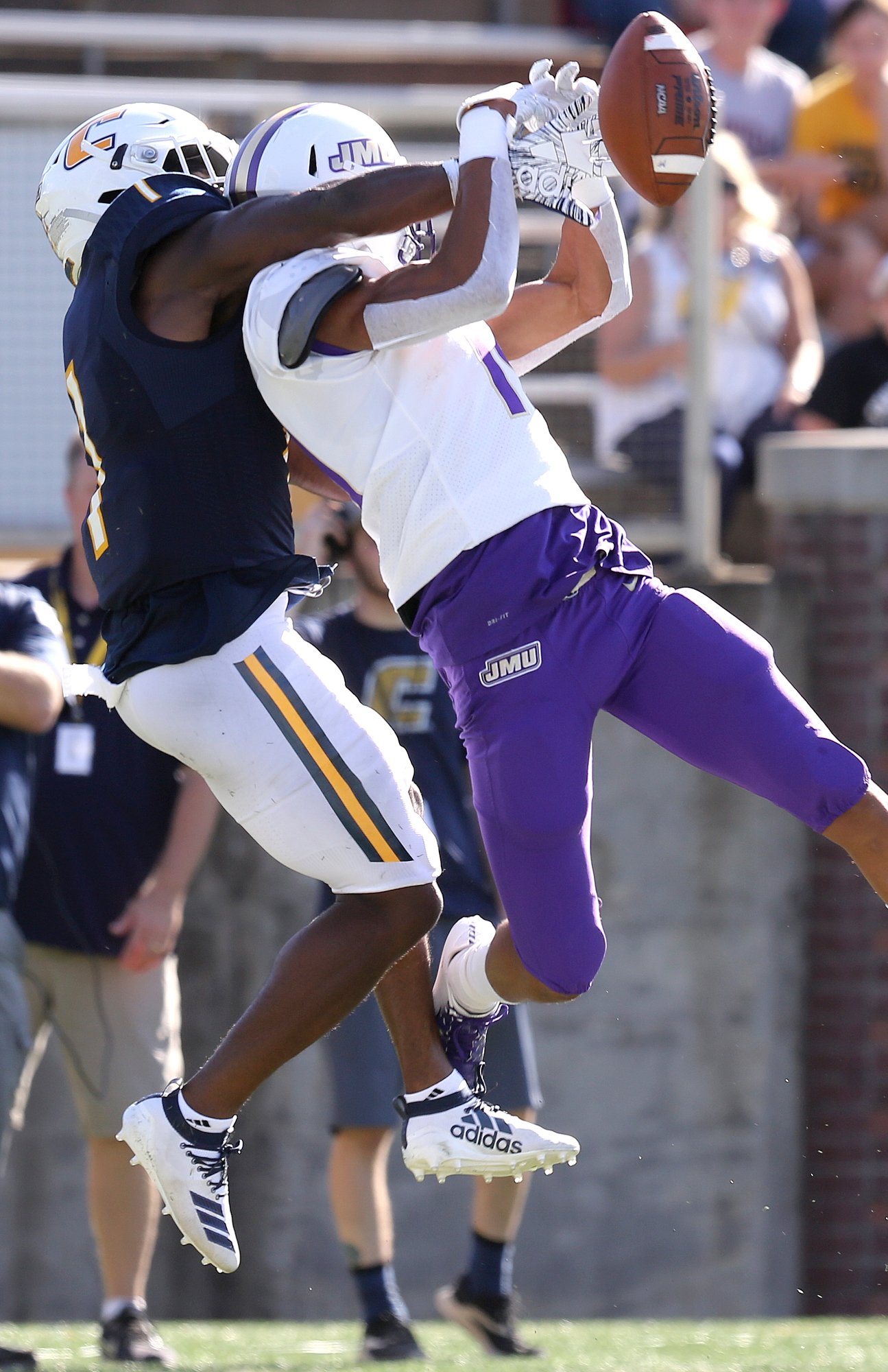 Staff photo by Erin O. Smith / UTC's Brandon Dowdell, left, breaks up a pass intended for James Madison's Devin Ravenel during Saturday's game at Finley Stadium. The second-ranked Dukes won 37-14.