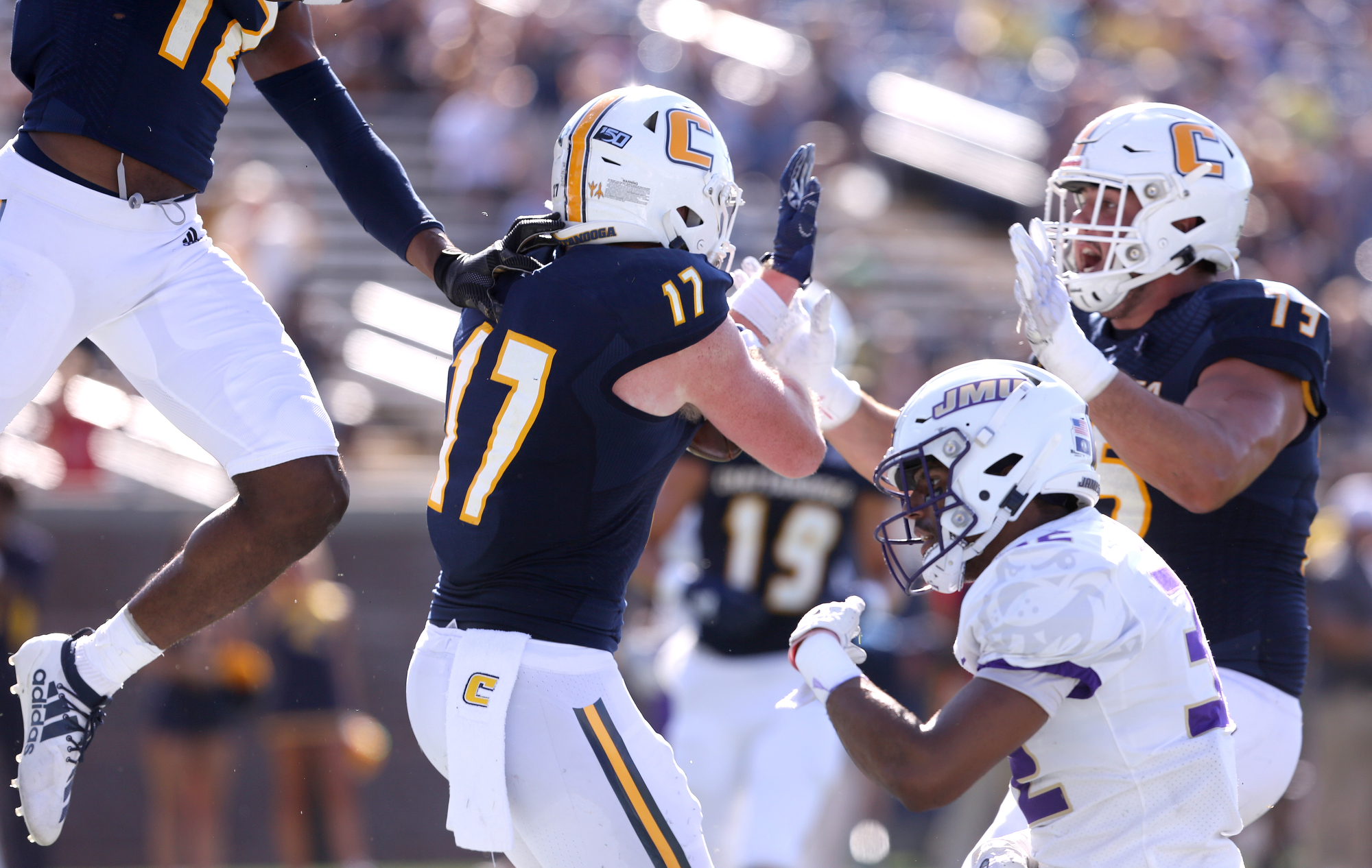 Staff photo by Erin O. Smith / UTC's Chris James (17) celebrates with teammates after scoring during the UTC vs. James Madison University NCAA football game Saturday, August 21, 2019 at Finley Stadium in Chattanooga, Tennessee. JMU was up 20-14 at the half.