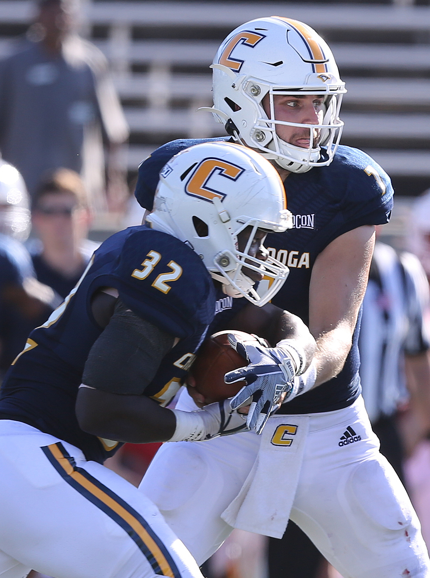 Staff photo by Erin O. Smith / UTC's Ailym Ford (32) takes a handoff from UTC quarterback Nick Tiano (7) during the UTC vs. James Madison University NCAA football game Saturday, August 21, 2019 at Finley Stadium in Chattanooga, Tennessee. JMU was up 20-14 at the half.