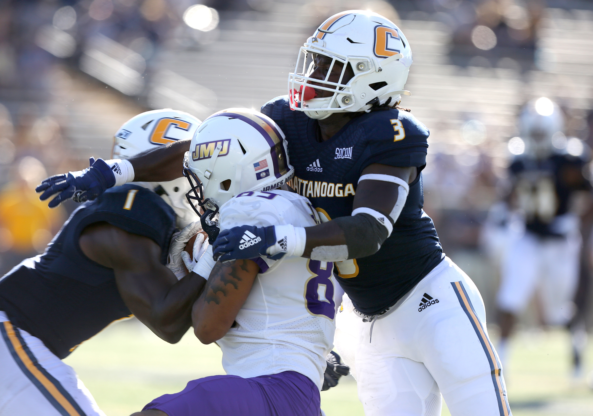 Staff photo by Erin O. Smith / James Madison University's Jake Brown (89) catches a pass as UTC's Brandon Dowdell (1) and Rashun Freeman (3) put a tackle on him during the UTC vs. James Madison University NCAA football game Saturday, August 21, 2019 at Finley Stadium in Chattanooga, Tennessee. JMU was up 20-14 at the half.