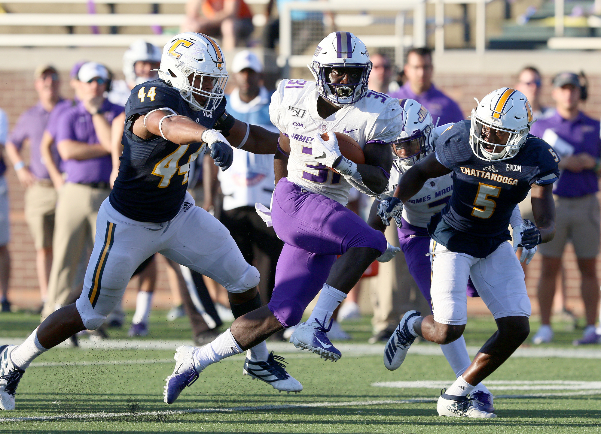 Staff photo by Erin O. Smith / UTC's Khayyan Edwards (44) and CaMiron Smith (5) chase down James Madison University's Percy Agyei-Obese (31) during the UTC vs. James Madison University NCAA football game Saturday, August 21, 2019 at Finley Stadium in Chattanooga, Tennessee. JMU beat UTC with a score of 37-14.