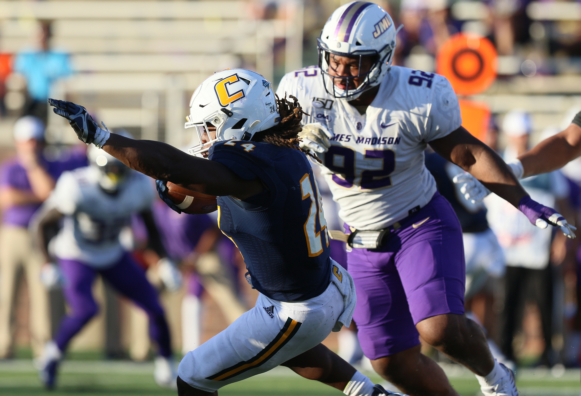 Staff photo by Erin O. Smith / UTC's Elijah Ibitokun-Hanks (24) runs the ball during the UTC vs. James Madison University NCAA football game Saturday, August 21, 2019 at Finley Stadium in Chattanooga, Tennessee. JMU beat UTC with a score of 37-14.