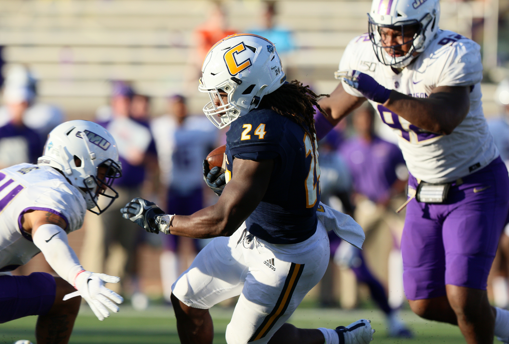 Staff photo by Erin O. Smith / UTC's Elijah Ibitokun-Hanks (24) runs the ball during the UTC vs. James Madison University NCAA football game Saturday, August 21, 2019 at Finley Stadium in Chattanooga, Tennessee. JMU beat UTC with a score of 37-14.