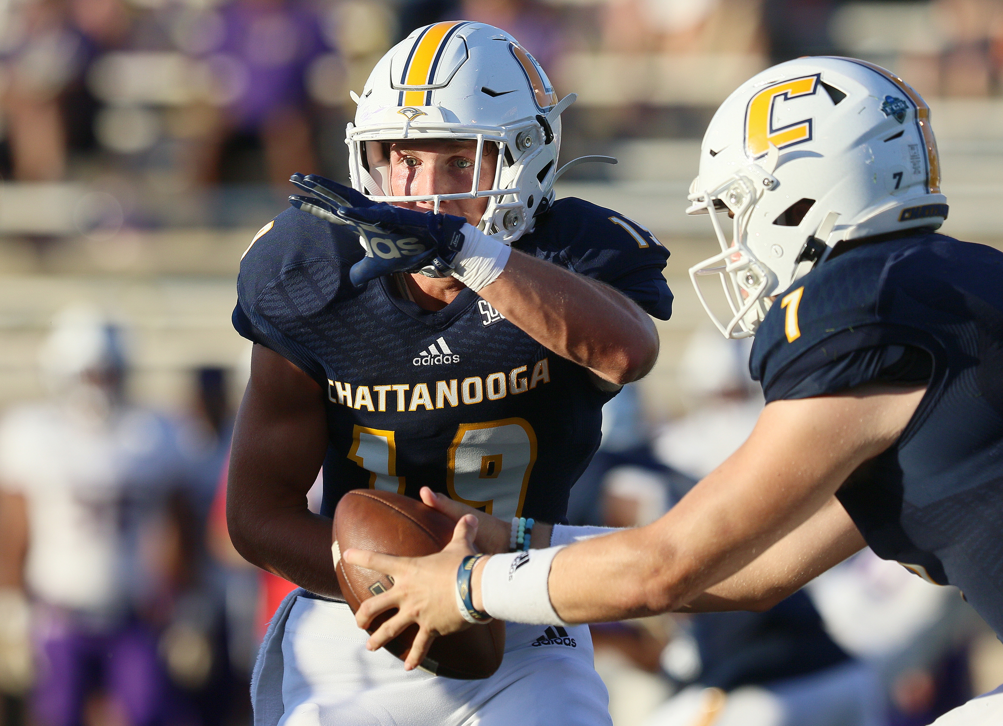 Staff photo by Erin O. Smith / UTC quarterback Nick Tiano (7) fakes a handoff to Bryce Nunnelly (19) during the UTC vs. James Madison University NCAA football game Saturday, August 21, 2019 at Finley Stadium in Chattanooga, Tennessee. JMU beat UTC with a score of 37-14.