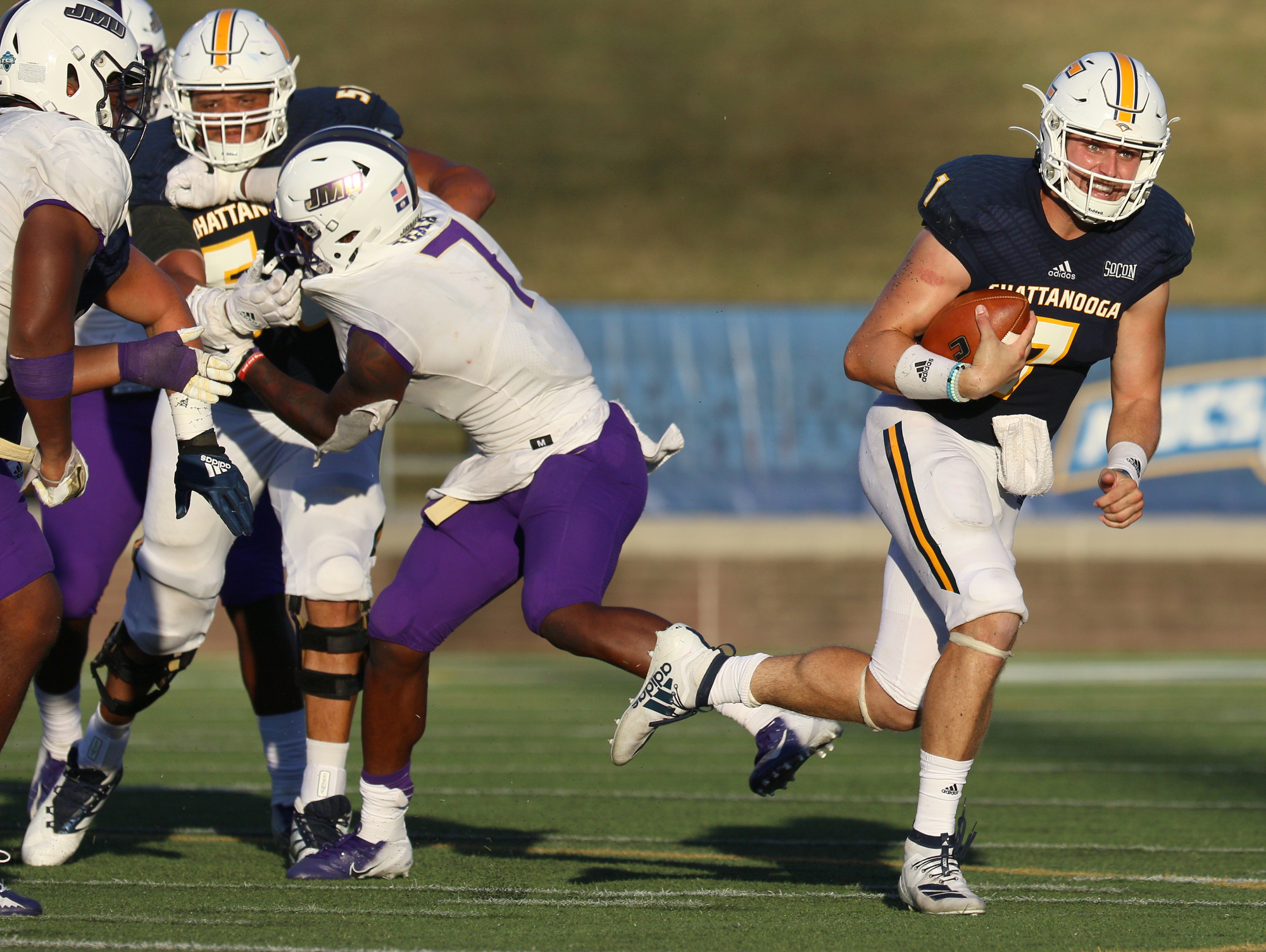Staff photo by Erin O. Smith / UTC quarterback Nick Tiano (7) runs the ball during the UTC vs. James Madison University NCAA football game Saturday, August 21, 2019 at Finley Stadium in Chattanooga, Tennessee. JMU beat UTC with a score of 37-14.