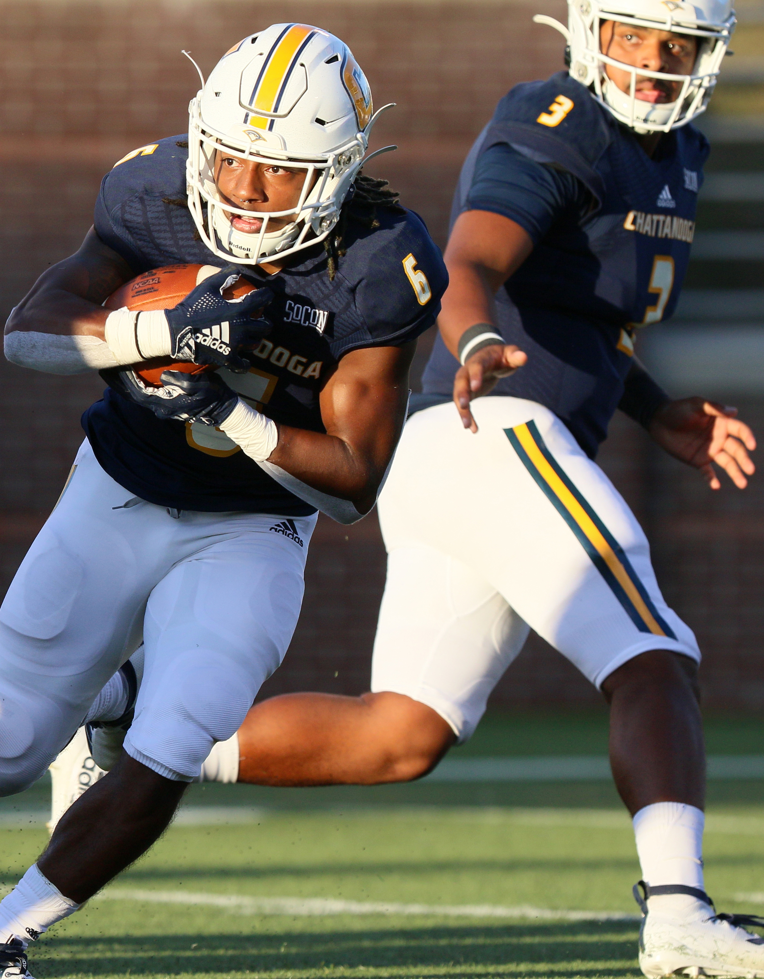 Staff photo by Erin O. Smith / UTC's Jeffrey Wood II (6) takes the handoff from quarterback Drayton Arnold (3) during the UTC vs. James Madison University NCAA football game Saturday, August 21, 2019 at Finley Stadium in Chattanooga, Tennessee. JMU beat UTC with a score of 37-14.