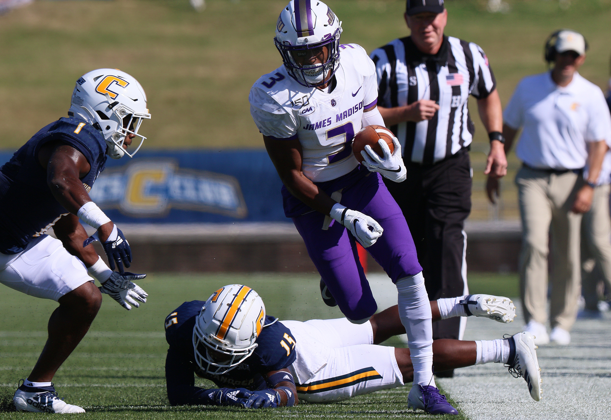 Staff photo by Erin O. Smith / UTC's Brandon Dowdell (1) and Kameron Brown (15) push James Madison University's Brandon Polk (3) out of play as he runs downfield during the UTC vs. James Madison University NCAA football game Saturday, August 21, 2019 at Finley Stadium in Chattanooga, Tennessee. JMU beat UTC with a score of 37-14.