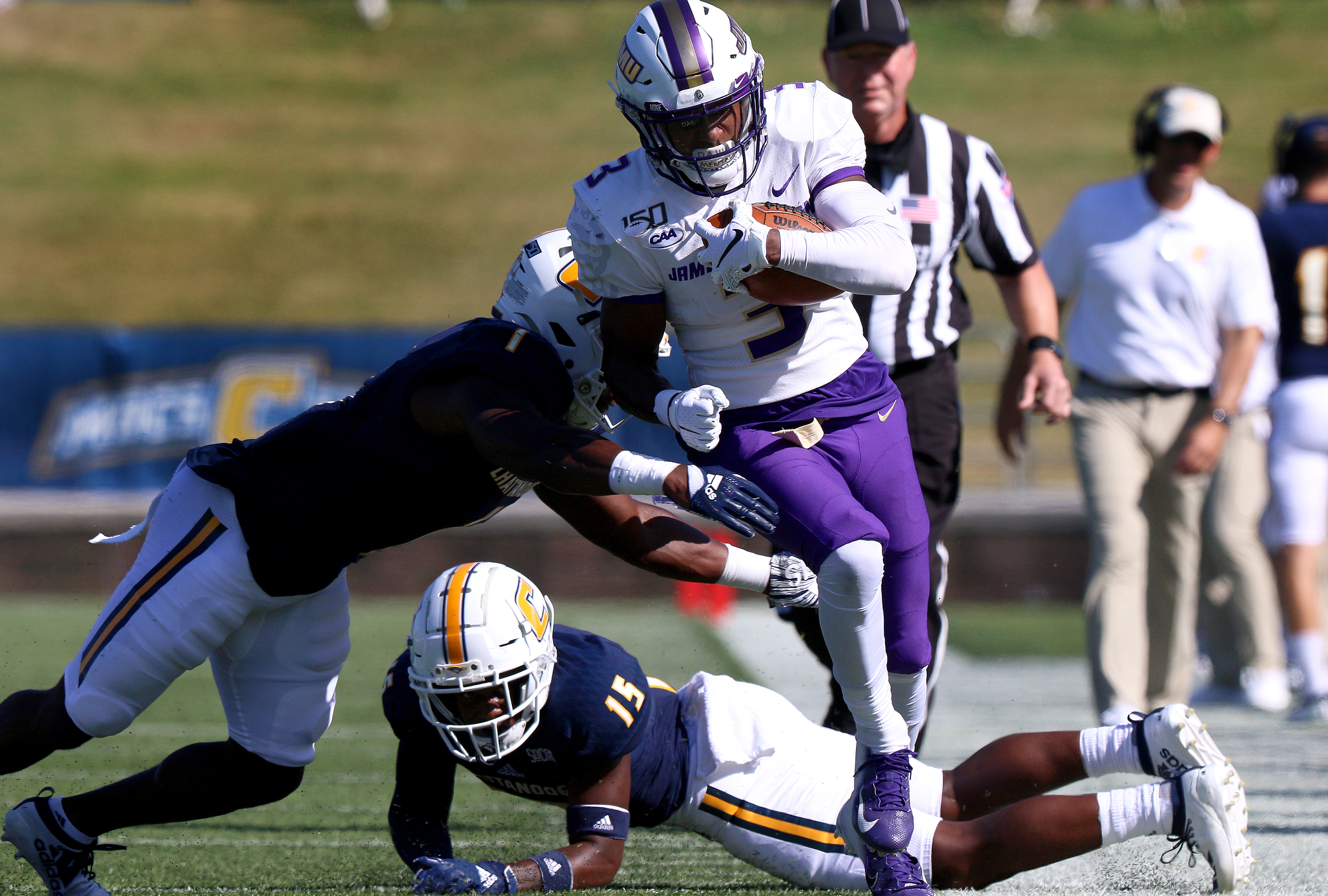 Staff photo by Erin O. Smith / UTC's Brandon Dowdell (1) and Kameron Brown (15) push James Madison University's Brandon Polk (3) out of play as he runs downfield during the UTC vs. James Madison University NCAA football game Saturday, August 21, 2019 at Finley Stadium in Chattanooga, Tennessee. JMU beat UTC with a score of 37-14.