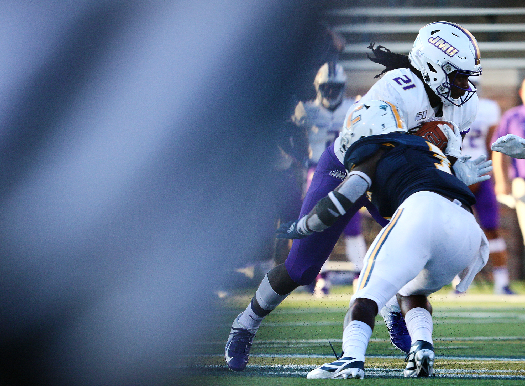 Staff photo by Erin O. Smith / James Madison University's Latrele Palmer (21) runs the ball during the UTC vs. James Madison University NCAA football game Saturday, August 21, 2019 at Finley Stadium in Chattanooga, Tennessee. JMU beat UTC with a score of 37-14.