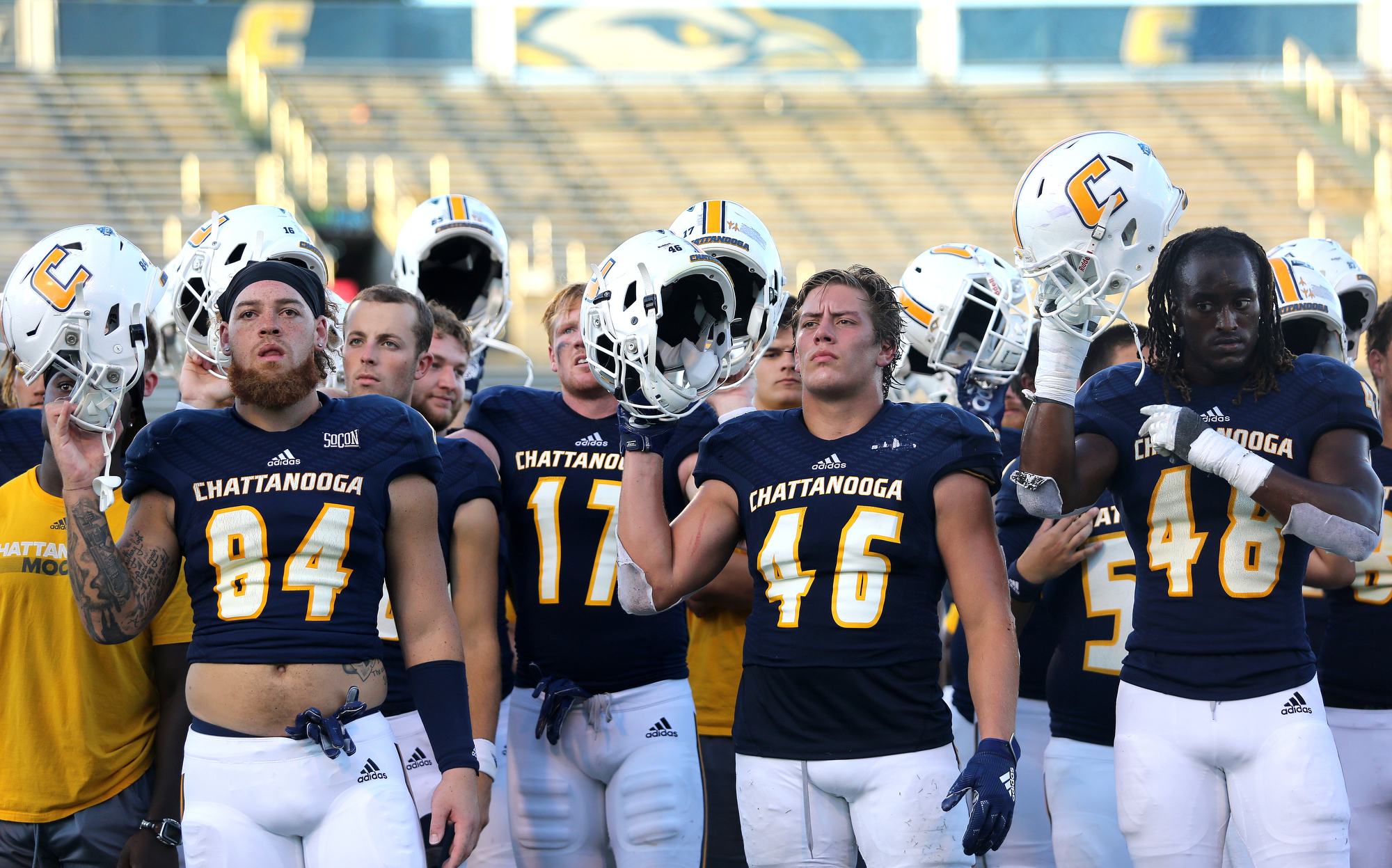 Staff photo by Erin O. Smith / UTC football players all over to the band as they perform the alma mater following the UTC vs. James Madison University NCAA football game Saturday, August 21, 2019 at Finley Stadium in Chattanooga, Tennessee. JMU beat UTC with a score of 37-14.
