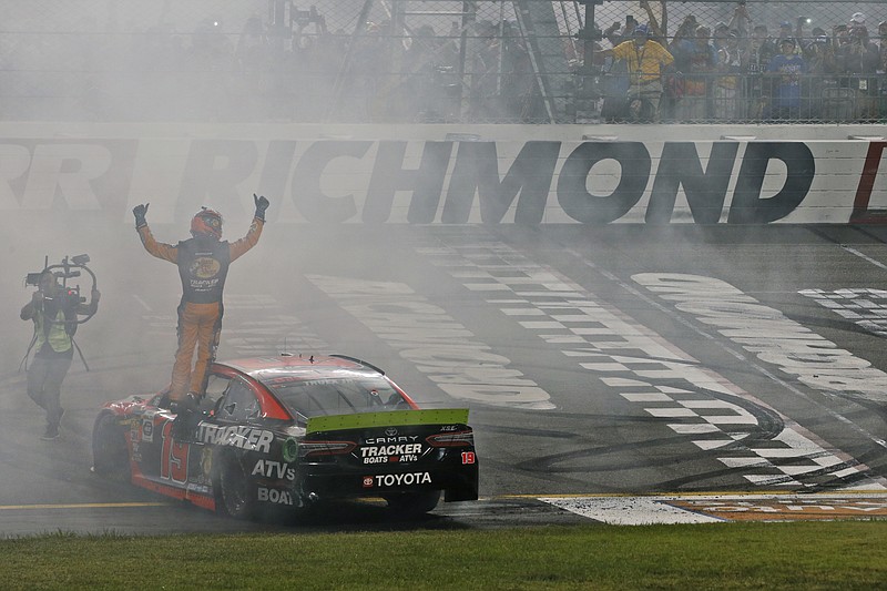 Associated Press photo by Steve Helber / Martin Truex Jr. celebrates his win in Saturday night's NASCAR Cup Series race at Richmond Raceway in Virginia.