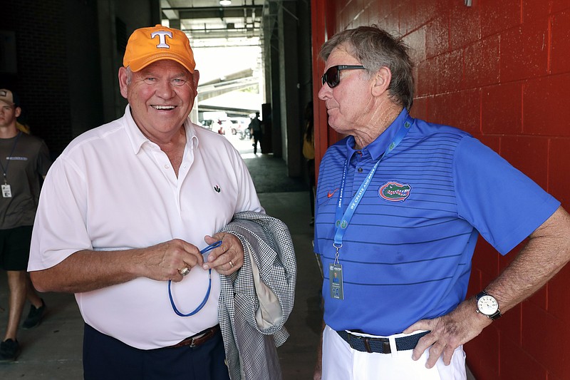 Former Tennessee coach and current athletic director Phillip Fulmer, left, talks with former Florida head coach Steve Spurrier before an NCAA college football game between Florida and Tennessee, Saturday, Sept. 21, 2019, in Gainesville, Fla. (AP Photo/John Raoux)