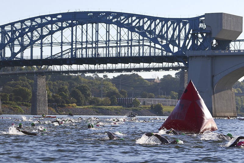Age group competitors pass between the Market and Walnut Street bridges while competing in the swim portion of a previous Little Debbie Ironman Chattanooga triathlon.