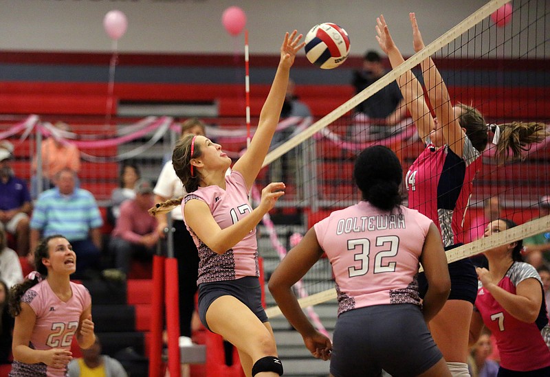 Staff photo by Erin O. Smith / Ooltewah's Cady Hughes (12) attempts to spike the ball over the net as Soddy-Daisy's Allie Lemacks (14) blocks the ball during the Soddy-Daisy vs. Ooltewah volleyball match at Ooltewah High School Tuesday, September 24, 2019 in Ooltewah, Tennessee. 