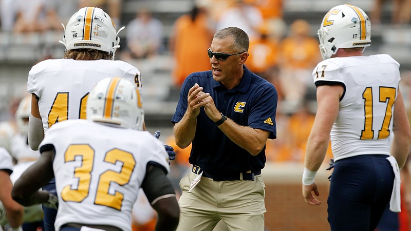 Staff photo by C.B. Schmelter / UTC head coach Rusty Wright claps as his team finishes stretching before their NCAA football game against Tennessee at Neyland Stadium on Saturday, Sept. 14, 2019 in Knoxville, Tenn.