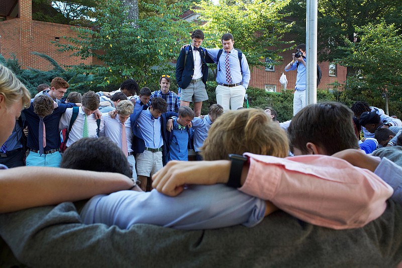 Staff photo by Wyatt Massey / Students of McCallie School gather at their flagpole to pray on Sept 25 as part of the annual "See You at the Pole" rally.