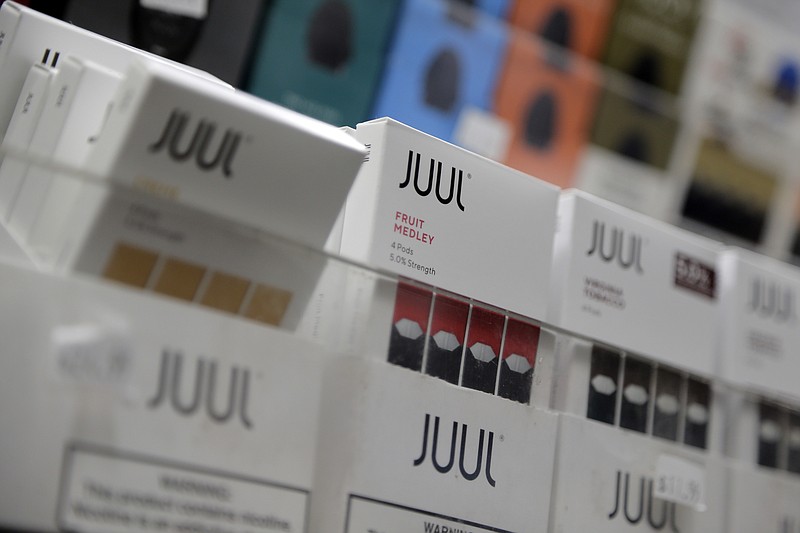 FILE - In this Dec. 20, 2018, file photo Juul products are displayed at a smoke shop in New York. Philip Morris and Altria have ended merger talks and JUUL’s CEO is stepping down from the top post as criticism over vaping continues to intensify. The companies confirmed last month that they were in discussions, more than a decade after splitting itself into two companies.  (AP Photo/Seth Wenig, File)